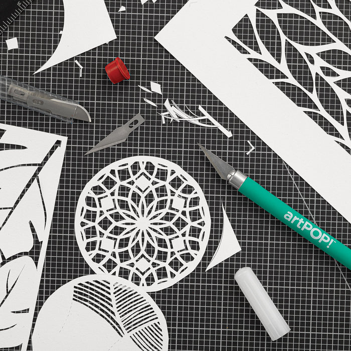 artPOP! Detail Knife - Green, on cutting mat with cutout paper shapes (close-up)