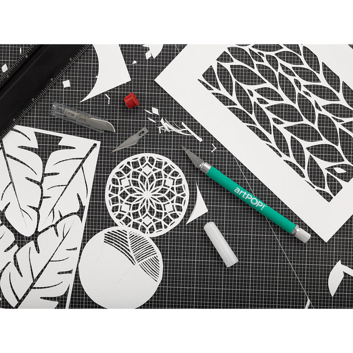 artPOP! Detail Knife - Green, on cutting mat with cutout paper shapes