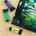 artPOP! Heavy Body Acrylic Paints - Set of 12 (Ultramarine Blue, Brilliant Green, and Lemon Yellow next to forest painting)